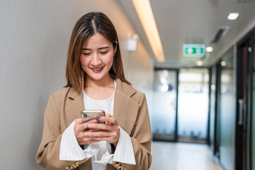 Shot of elegant young business woman smiling and  using mobile phone, Copy space.