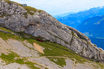 Obraz premium Cogwheel train climbing to the top of Mount Pilatus in Canton Lucerne, Switzerland. World's steepest cogwheel railway