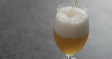 pour unfiltered wheat beer into tulip glass with copy space
