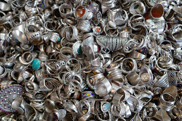 Marrakech, Morocco - Feb 10, 2023: Metal rings with colored stones in a market in a souk