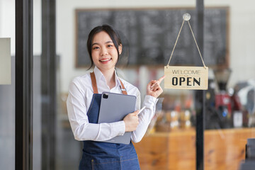 Startup successful asian small business owner sme beauty girl stand with tablet in coffee shop restaurant. Portrait of asian tan woman barista cafe owner. SME entrepreneur seller business sme concept