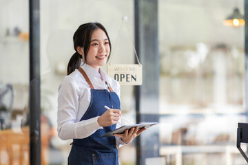 Startup successful asian small business owner sme beauty girl stand with tablet in coffee shop...