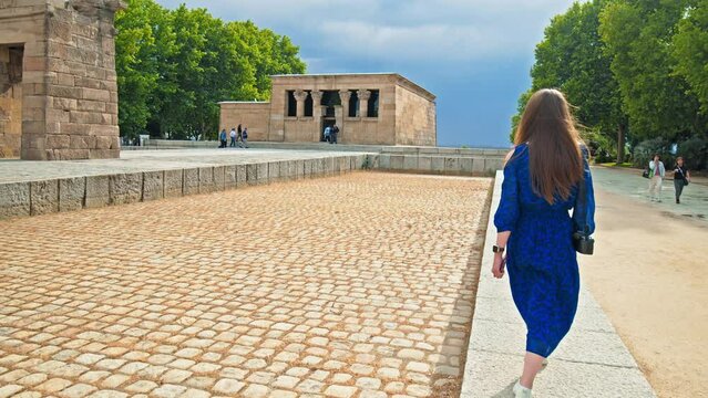 A Tourist woman visiting the Temple of Debod Monument in Madrid Spain, Europe. A female walks by the Ancient Egyptian temple and museum from Aswan