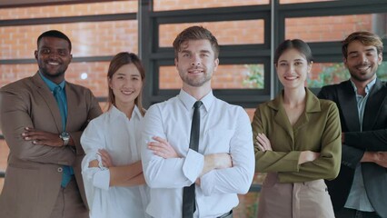 Group of diverse businesspeople standing with crossed arms smiling and looking at camera. Successful business team standing with crossed arms looking at camera. Business team concept - Powered by Adobe