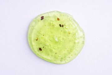Transparent green cosmetic sample texture with bubbles. Cosmetic peeling gel with fruits. Cosmetic...