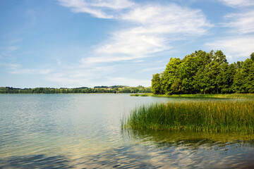 Lake landscape. Summer  time background. Szelment Wielki lake in Poland. Blue cloudy sky over water surface panoramic view. Tranquil rural view. Weekend camping. - obrazy, fototapety, plakaty