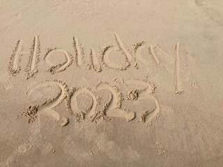 Holiday 2023 inscription in sand