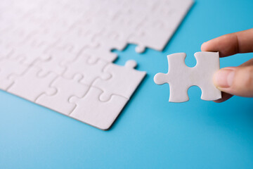 jigsaw connection White puzzle in the hands of a businessman Business team assembles jigsaw puzzle.