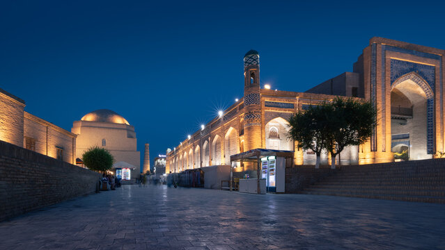 Ichan Kala old city at night with illuminated Islam Khoja minaret, ancient madrasah, Khiva, Uzbekistan