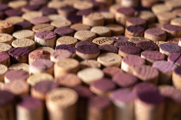 Close up of many extracted wine corks with various intensity red color and focus on 2019 marking