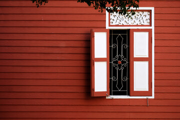Obraz premium window with red shutters