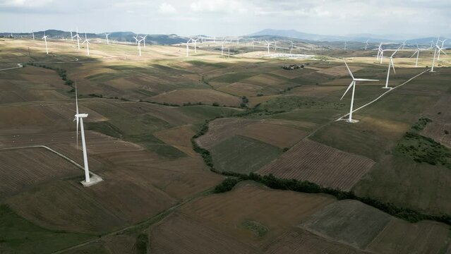 aerial view from the drone of a wind turbine farm producing renewable energy from the wind. We are in near Bisaccia in Campania Italy