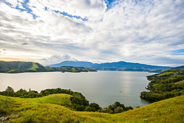 Beautiful landscape of Sentani Lake, Papua, Indonesia. Lake Sentani is a tropical, shallow, and at low-altitude open lake located at the northeast extremity of the Jayapura Regency, Papua, Indonesia.