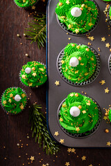Sweet green cupcakes made of green cream for Christmas.