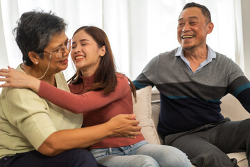 Portrait enjoy happy smiling love asian family.Senior mature father hug with elderly mother and young adult woman play laughing and having fun together at home.insurance concept
