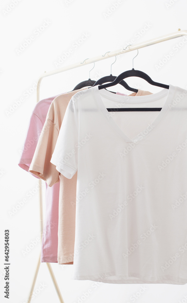 Wall mural women's t-shirts on  hanger on  white background