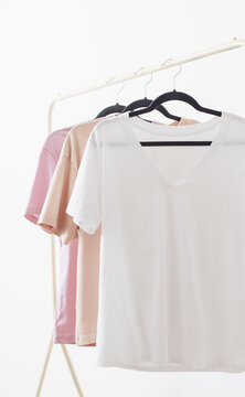 women's t-shirts on  hanger on  white background