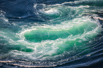 Blue waves of water of the river and the sea meet each other during high tide and low tide.