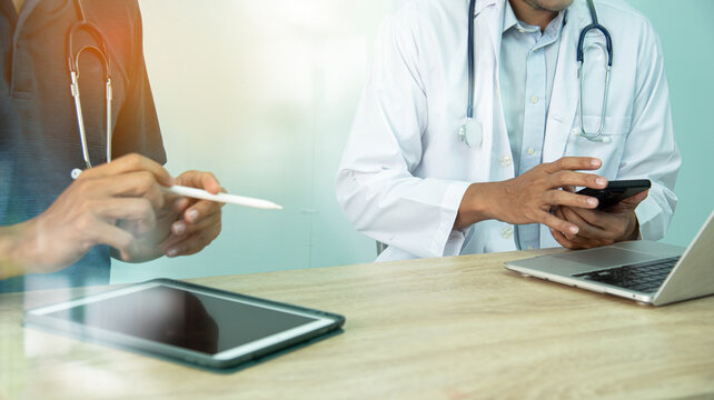 Smart medicine doctors working with computer notebook and digital tablet  at desk in the hospital. Medical concept.Medical teamwork discussion