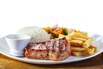 Grilled pork steak with rice, french fries and salad