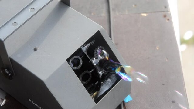 Soap bubble generator close up. Working operation Soap Bubble Generator and inflating soap bubbles. Bubble machine. Automatic blowing soap bubbles. Creating bubbles. Entertainment, celebration, party