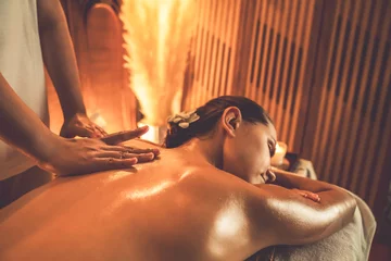 Fotobehang Massagesalon Closeup woman customer enjoying relaxing anti-stress spa massage and pampering with beauty skin recreation leisure in warm candle lighting ambient salon spa at luxury resort or hotel. Quiescent