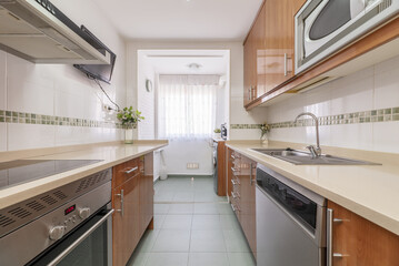 A kitchen that gets a lot of light with walls furnished