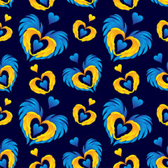 Fototapeta premium Vector seamless pattern with wings and hearts in yellow and blue colors on a dark blue background. Ukrainian flag colors. Scrapbooking paper.