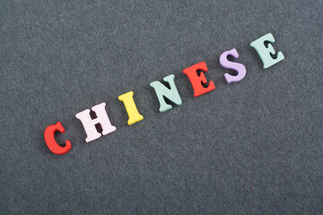 CHINESE word on black board background composed from colorful abc alphabet block wooden letters,...