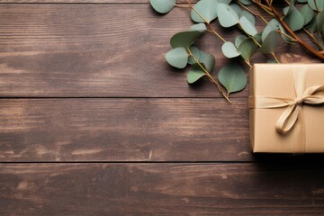 Vintage wooden background with eucalyptus leaves and gift box Flat lay Copy space