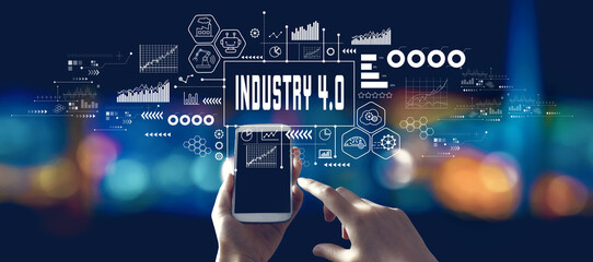 Industry 4.0 theme with person using a smartphone in a city at night
