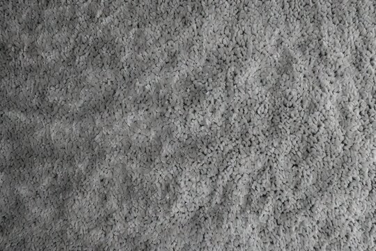 Close up view of gray monochrome carpet texture as displayed seamlessly from above