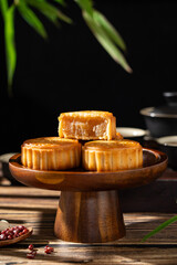 Traditional Chinese mid autumn festival food moon cake on wooden table	