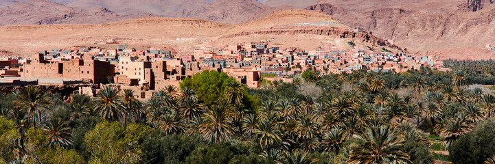 Fototapeta na wymiar Moroccan kasbah. A village by an oasis with palm trees. Atlas Mountains, Morocco