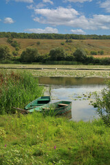 Fishing boats are moored near the overgrown shore called the Southern Bug.