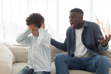Angry Black Father Shouting At Scared Little Son At Home