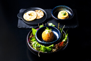 Closeup of some spanish croquettes in a bed of lettuce served as tapas