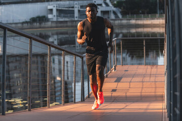 Confident young African man in sportswear enjoying his morning jog outdoors
