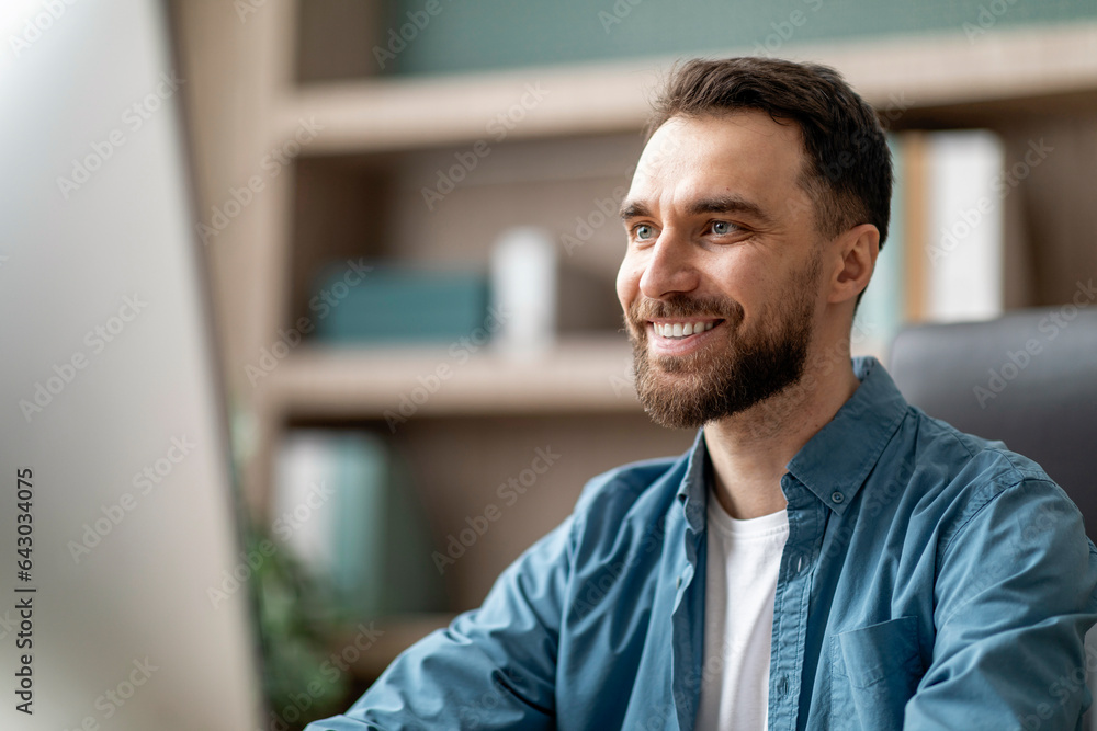 Aufkleber portrait of smiling handsome businessman working on computer in office