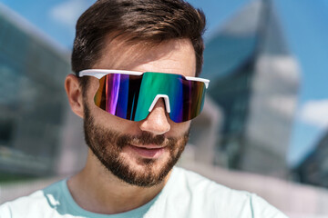 Portrait of a man in fitness sports glasses. The athlete is a guy with a beard.