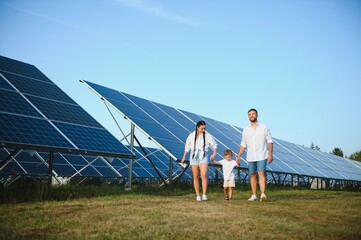 Enthusiastic father showing potential of alternative energy. Contemporary family looking at new...