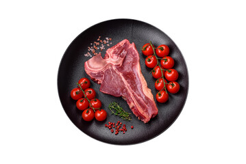 Raw fresh juicy beef t-bone steak with salt, spices and herbs