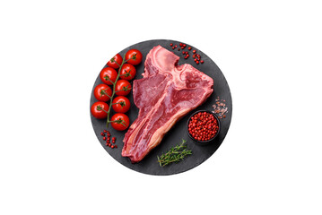 Raw fresh juicy beef t-bone steak with salt, spices and herbs