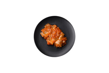 Delicious fresh sea fish cut into pieces and baked in tomato sauce