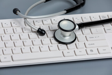 Stethoscope and computer keyboard. Medical records, data security, telehealth, and telemedicine...