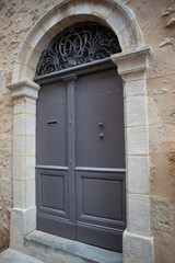 Fototapeta na wymiar Old wooden door of a classic stone house