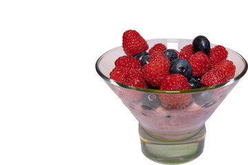 Fresh wild berry fruit on top of fruit yogurt in jar