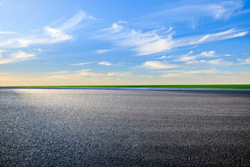 Asphalt road and colorful sky clouds at sunset