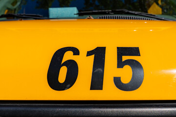 Front of a parked yellow school bus number 615