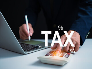 Businessman using computer and calculator for tax calculation, online personal tax return form for tax payment, financial research report, tax return calculation.